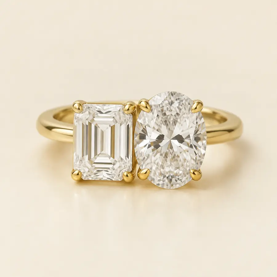 East-west two-stone ring with an emerald cut and an oval diamond
