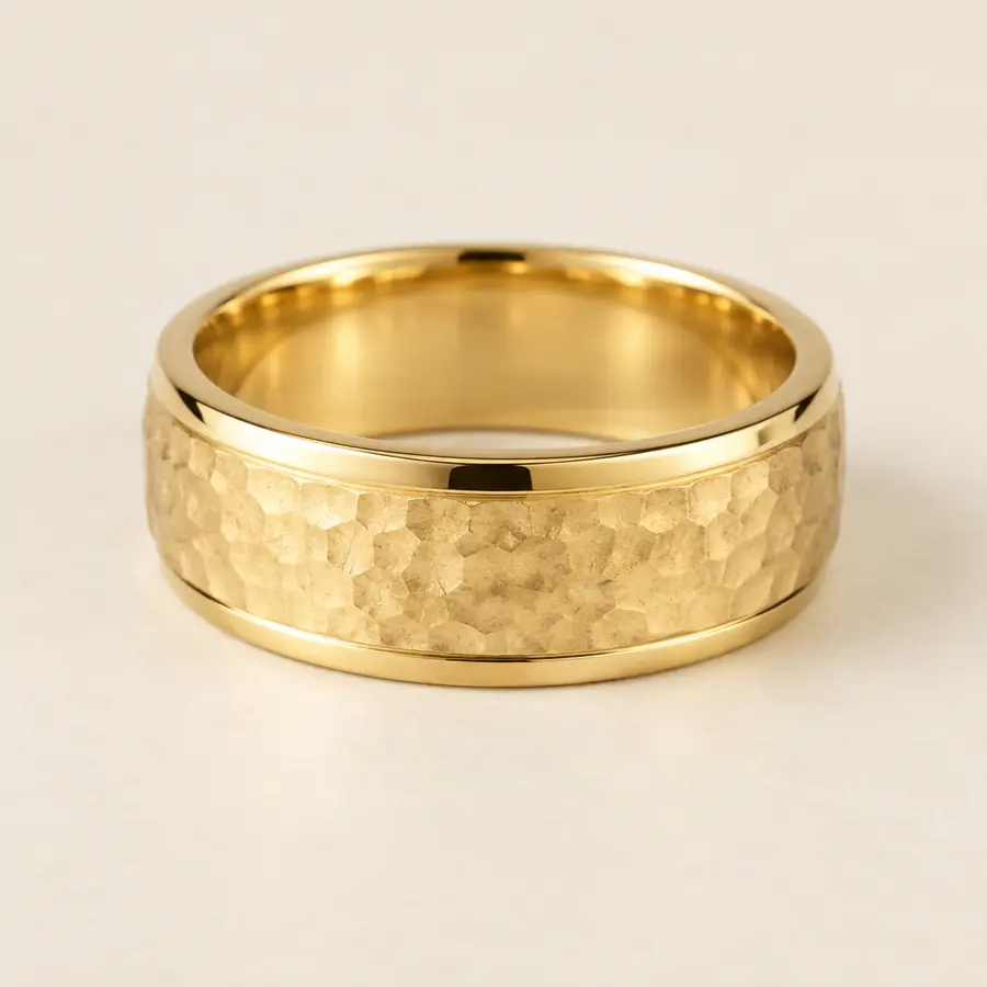 Men's 18k yellow gold wedding band with a hammered texture and polished edges